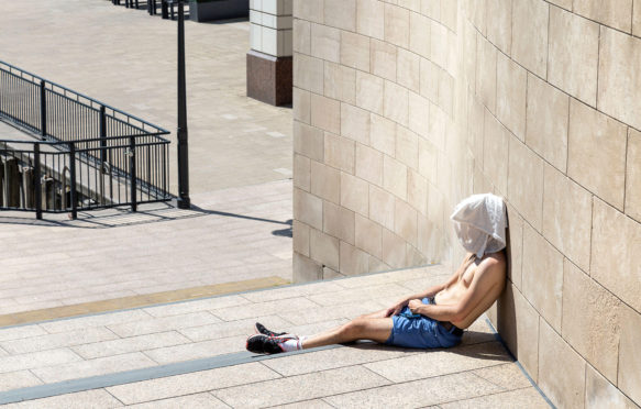 Man with a t-shirt over his head during August 2020 heatwave