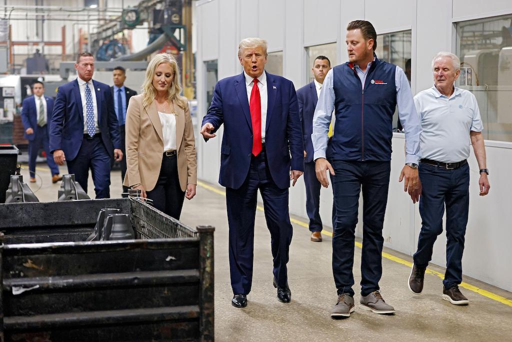 Former President Donald Trump tours Drake Enterprises, an automotive supply company, in Michigan state.