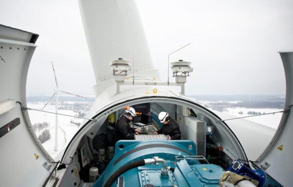 EM6TE7 Two maintenace men work on a wind turbine in northern Poland near Kobylnica during the winter.