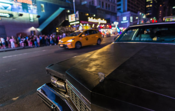 Classic American car parked at night on Seventh Avenue , New York City, USA. 30 July 2018. Credit: Jordi De Rueda Roigé / Alamy Stock Photo