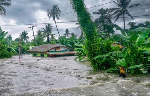 Rising water levels submerge a house as heavy monsoon rains cause major floods in Philippines