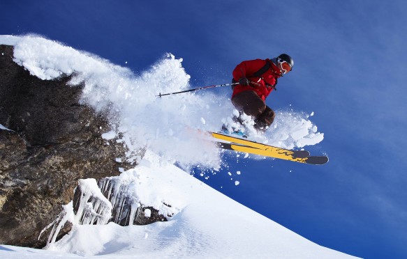Skier jumping on snowy slope in Switzerland