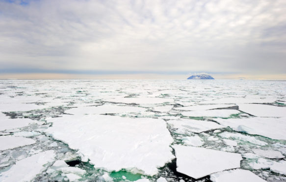 Small island in the Ross Sea, Antarctica, with pack ice in the foreground